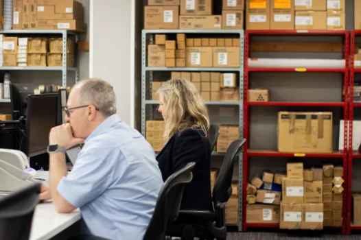 man and woman using computers
