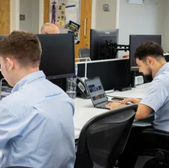 two men using laptops