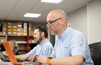 two men using laptops